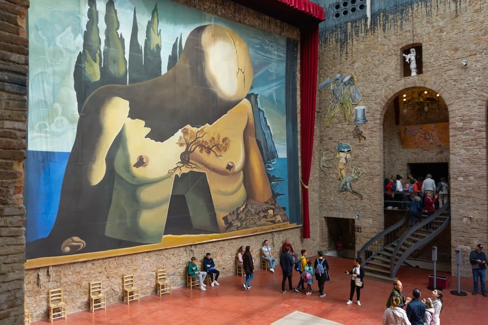 The red walls of the Dalí Theatre-Museum in Figueres, crowned with giant white eggs and a glass dome