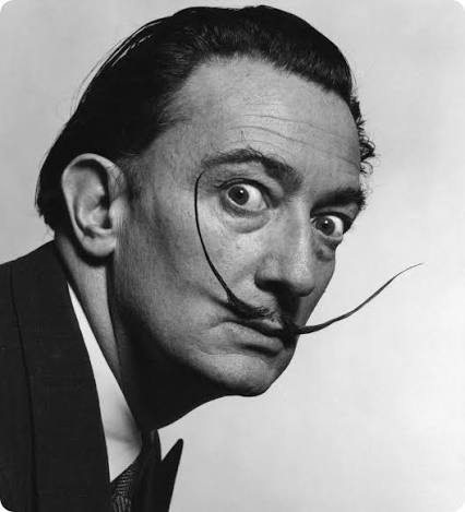 Black-and-white portrait photograph of Salvador Dalí with his long, upturned moustache